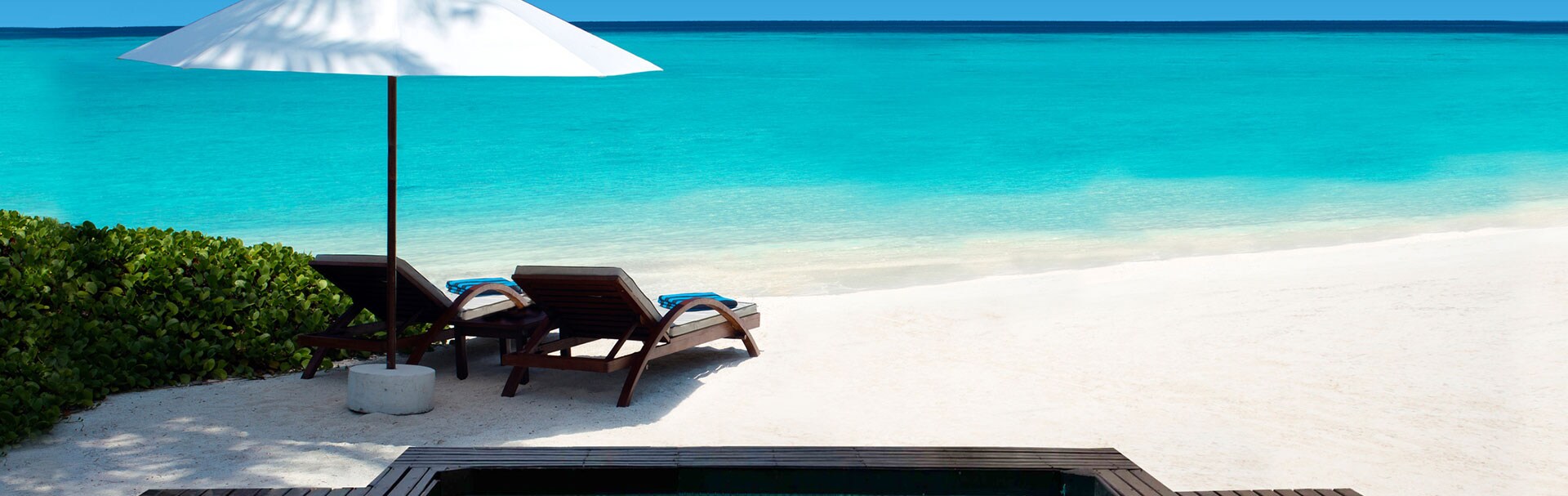 Topical Beach Destination with Lounge Chairs and Umbrella