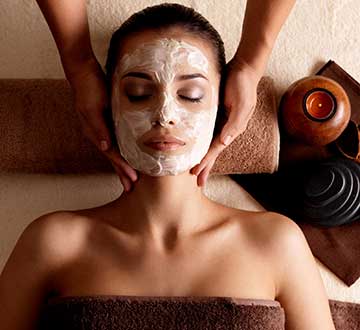 Woman getting facial at resort spa